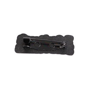 Detail view of matte black alloy brooch back base with secure rotating safety pin