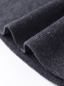 Dettaglio macro del tessuto a maglia grigio scuro che mostra la trama fine e la qualità