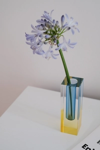 Detail of blue cylindrical inner and yellow base in clear acrylic gradient vase