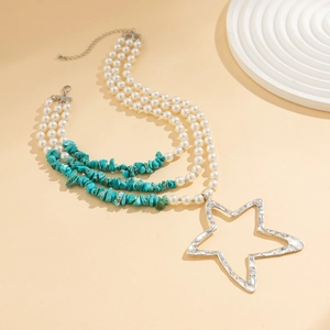 Detail of bohemian triple layer necklace with turquoise beads and silver star charm
