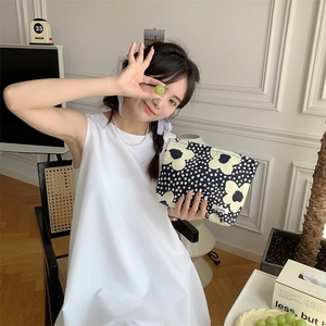 Floral cotton makeup bag in dark blue shown in a lifestyle scene with a natural aesthetic