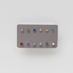 Macro shot of twelve colorful round cubic zirconia earrings in four-prong silver settings