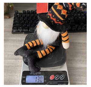 Weight measurement of 130g for Halloween faceless gnome with striped legs on scale