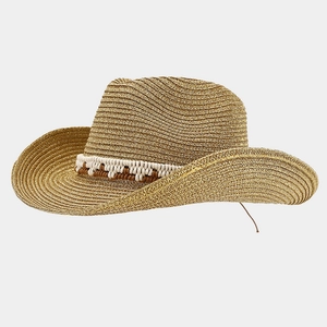 Detail of wide brim straw cowboy hat with decorative woven rope band for summer sun protection
