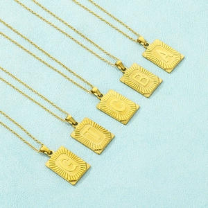 Detailed view of 18k gold plated stainless steel square alphabet pendant necklaces