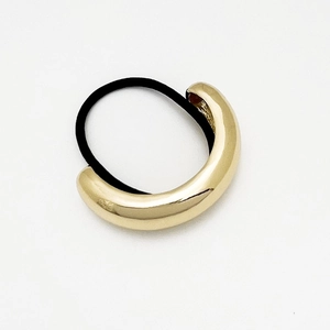 Macro detail of high-elasticity black hair tie with polished gold alloy U-shaped tube