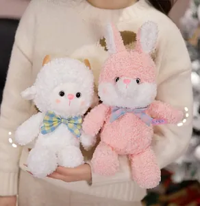 Close-up of cute plush bunny and lamb toys with plaid bows in soft textures
