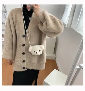 Cute white plush bear crossbody bag styled with a khaki cardigan in a mirror selfie