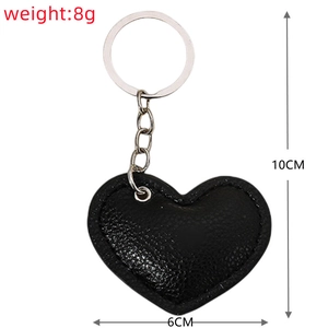 Detail view of black PU leather heart keychain with 10cm length and 8g weight specs