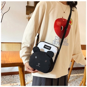 Detail of cute panda cartoon crossbody bag featuring a contrast design and woven strap