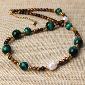Detail of beaded necklace with tiger eye stone, green agate beads and white pearls
