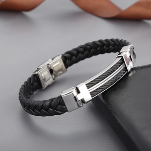 Detail of black woven leather bracelet with double-row stainless steel clasp for men