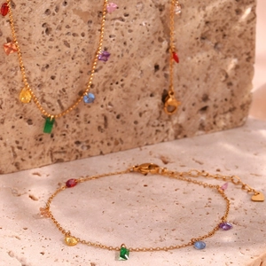 Detail of 18K gold plated jewelry set with colorful pear and round shaped gemstones