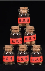 Set of six mini glass bottles with cork stoppers containing osmanthus scent incense balls