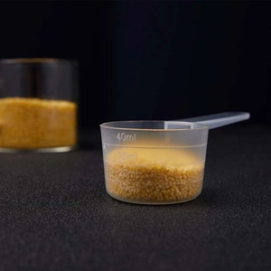 Clear 40ml plastic measuring scoop with handle and scale markings for dry and liquid goods
