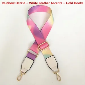 Close-up of a rainbow gradient wide bag strap with white leather ends and gold metal hooks