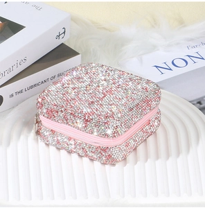 Detailed view of square jewelry box with pink and silver rhinestones and zipper closure