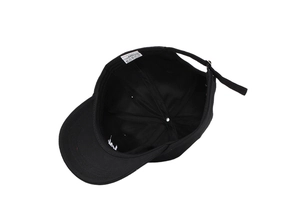 Detail view of cotton baseball cap interior with adjustable metal buckle and embroidery