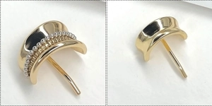 Detailed view of polished gold metal hair hook with silver bead inlay and sturdy fastening pin