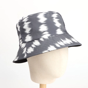 Detailed view of the wave-like tie-dye pattern on a sturdy canvas bucket hat texture