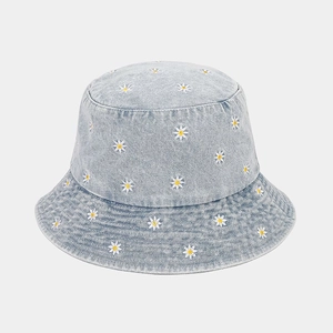Denim bucket hat with white daisy embroidery and washed blue fabric for women