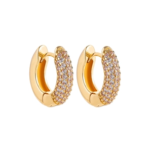 Detailed macro view of 18K gold hoop earrings featuring three rows of micro-set crystals