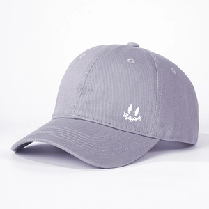 Detail view of the white smiley face embroidery on the side of this lavender baseball cap