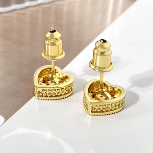 Detailed macro view of gold plated heart studs with micro-pave cubic zirconia stones