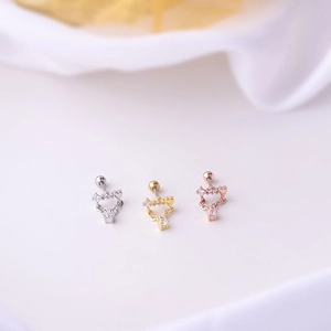 Detailed view of heart-shaped stainless steel stud earrings in silver, gold, and rose gold