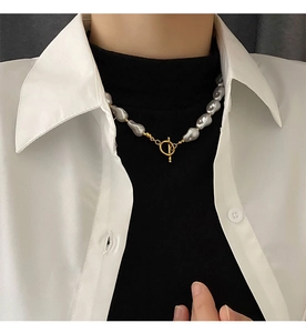 Close-up of irregular baroque pearl necklace with a vintage gold toggle clasp