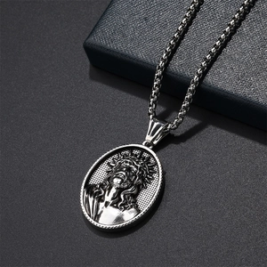 Macro shot of vintage silver Jesus Christ relief pendant with textured box chain