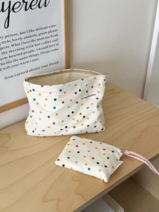 Set of two white polka dot fabric pouches including a large zipper bag and drawstring bag
