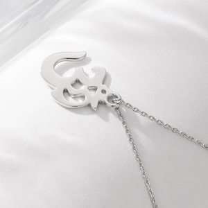 Detailed close-up of polished S925 sterling silver Om symbol pendant on a fine chain