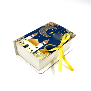 Detailed view of Eid Mubarak gift box with gold moon pattern and yellow silk ribbon