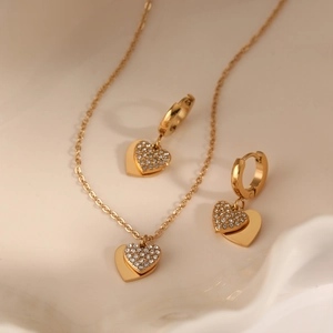 Elegant gold double heart jewelry set with necklace and earrings featuring zircon stones