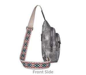 Side view of gray canvas chest bag with three zipper pockets and ethnic woven strap