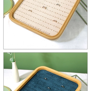Bamboo jewelry tray featuring green velvet lining and multiple ring storage slots