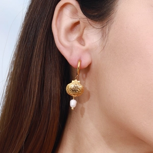 Elegant 18K gold stainless steel hoop earrings with shell pendant and white pearl on model
