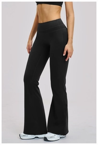 Detail of high-waisted black flared yoga pants with slim fit and wide leg opening
