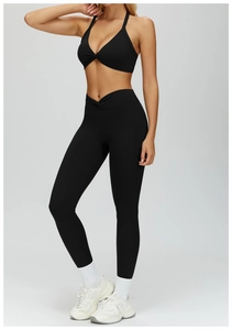 Detail of black V-neck twist yoga bra and high-waisted leggings with cross-waist design