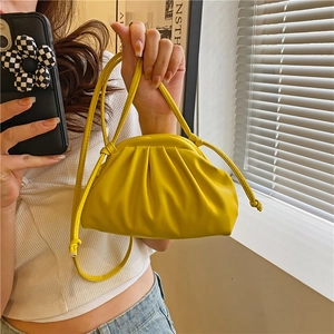 Minimalist bright yellow dumpling cloud bag with pleated design and thin shoulder strap