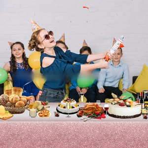 Detail of party confetti popper with rose pattern held by children at a birthday celebration