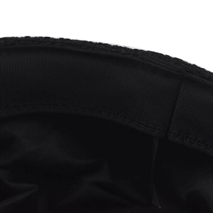 Detail shot of black newsboy cap interior showing elastic sweatband and premium stitching
