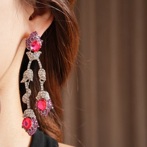 Detail of vintage silver tassel earrings with pink oval stones and rhinestones on model
