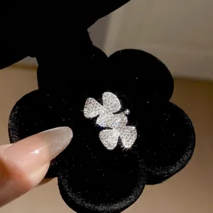 Elegant silver-tone four-leaf clover ear cuff featuring sparkling cubic zirconia stones