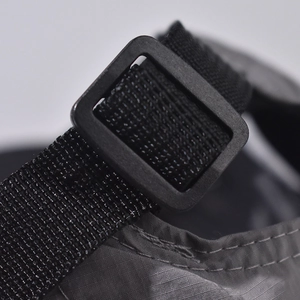Detail of adjustable black plastic buckle and nylon strap on short brim baseball cap