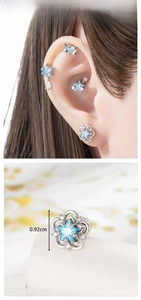 Detailed close-up of light blue star earrings with a 0.92cm diameter size measurement