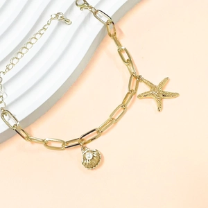 Elegant gold chain bracelet featuring seashell and starfish charms with pearls for women