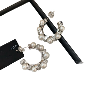 Elegant C-shaped silver earrings with white pearls and sparkling rhinestone accents