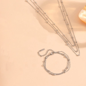 Close-up of silver multilayer beaded titanium steel necklaces and bracelets with shells